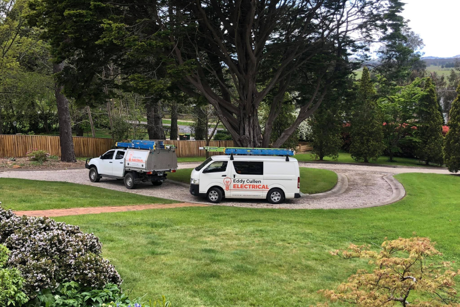 Electricians from Eddy Cullen Electrical arriving in their branded van at a client's location to provide electrical solutions.
