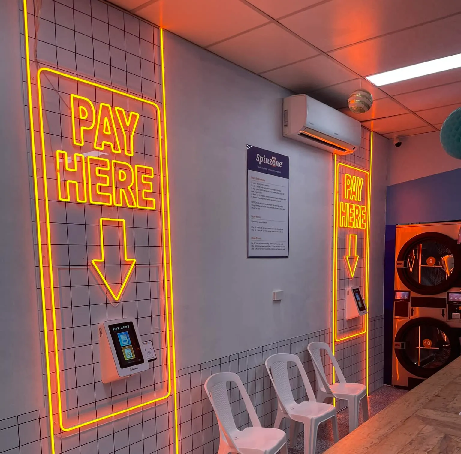 Commercial electrical fit-out in Bundanoon with neon 'Pay Here' signs and self-serve payment terminals