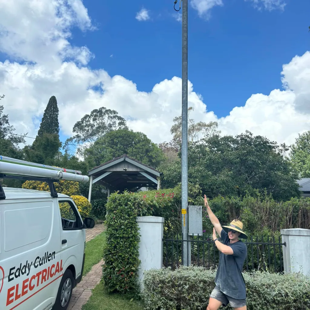 Eddy Cullen Electrical technician pointing to overhead service line during a Level 2 electrical job at a residential property.