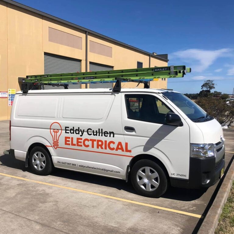 An Eddy Cullen Electrical work van parked outside of a commercial electrical job.